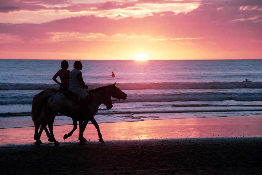 Horseback riding at sunset on the beach in Costa Rica by Vacancy Rewardsa